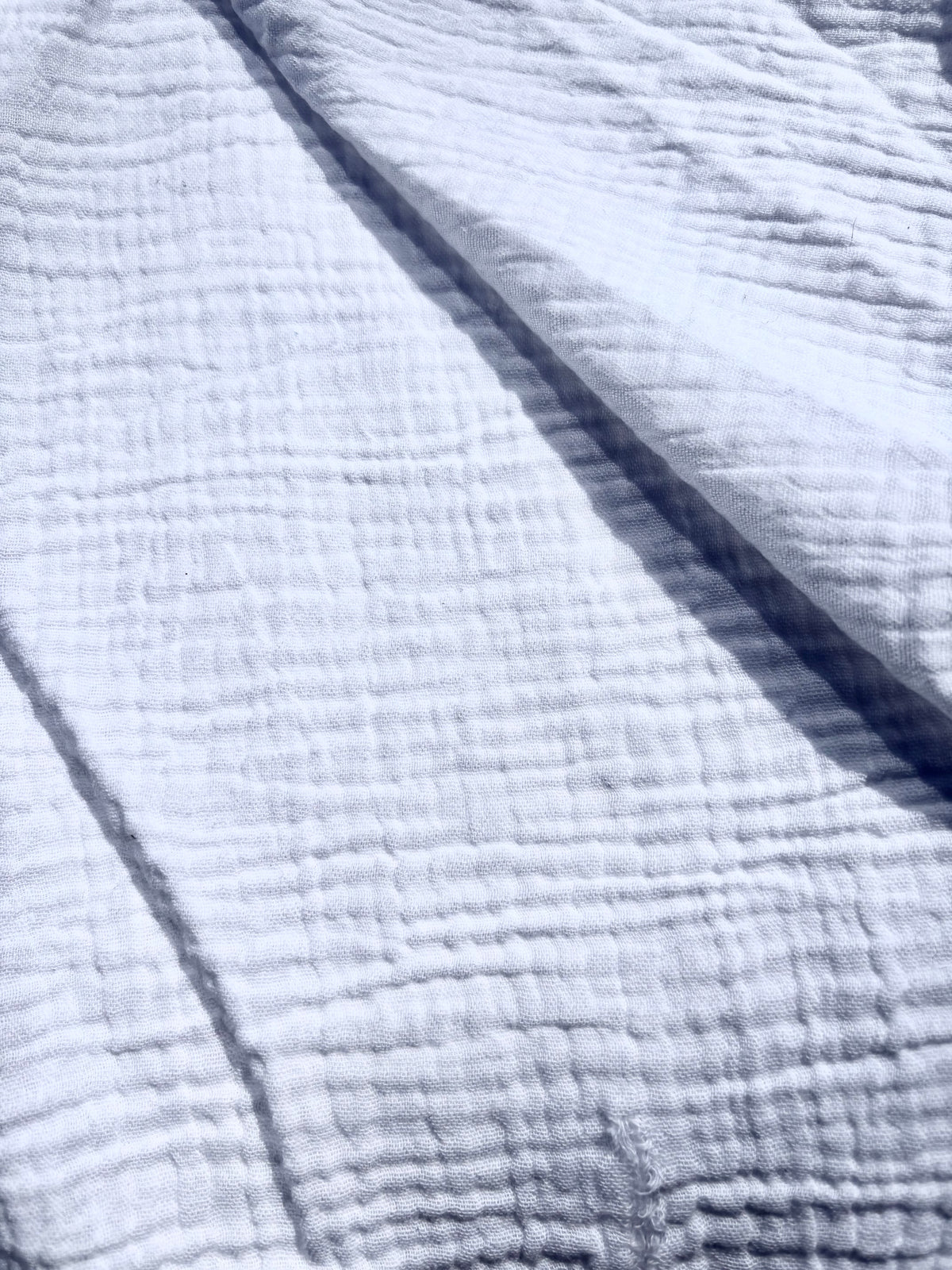 Close-up of textured double-gauze cotton in white.