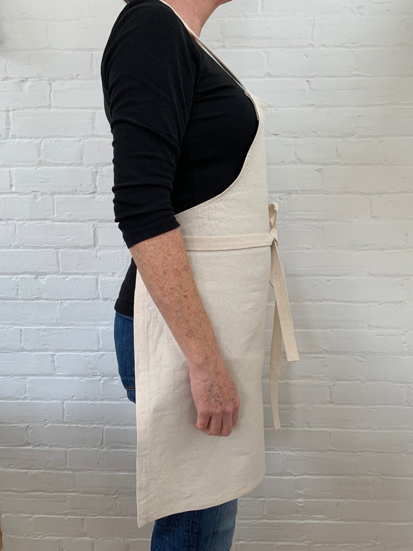 Side view of woman wearing cotton canvas apron