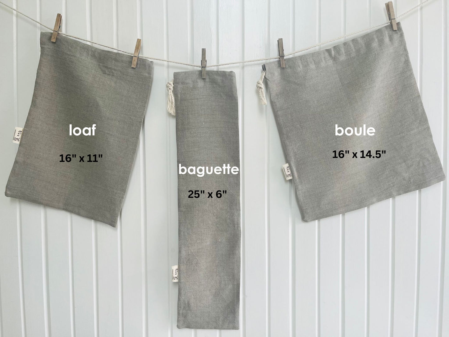 Three natural linen bread bags labeled 'loaf', 'baguette', and 'boule' with dimensions on a white background.