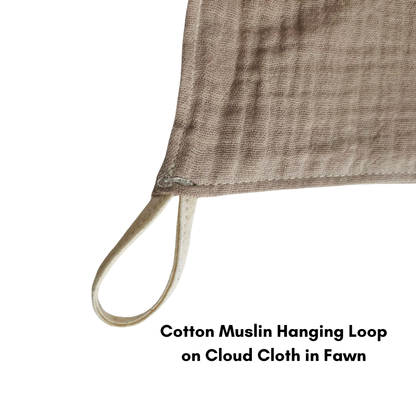 A close up of a muslin cotton loop sewn into a cloud cloth in fawn