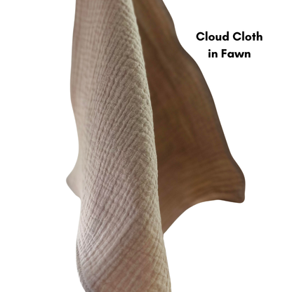 A cloud cloth in fawn (taupe) hangs. the background is pure white