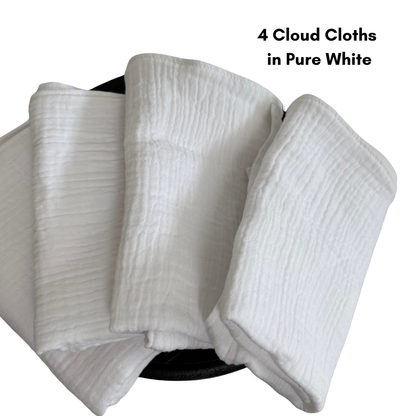 4 cloud cloths in pure white are folded and fanned out on a wooden pedestal