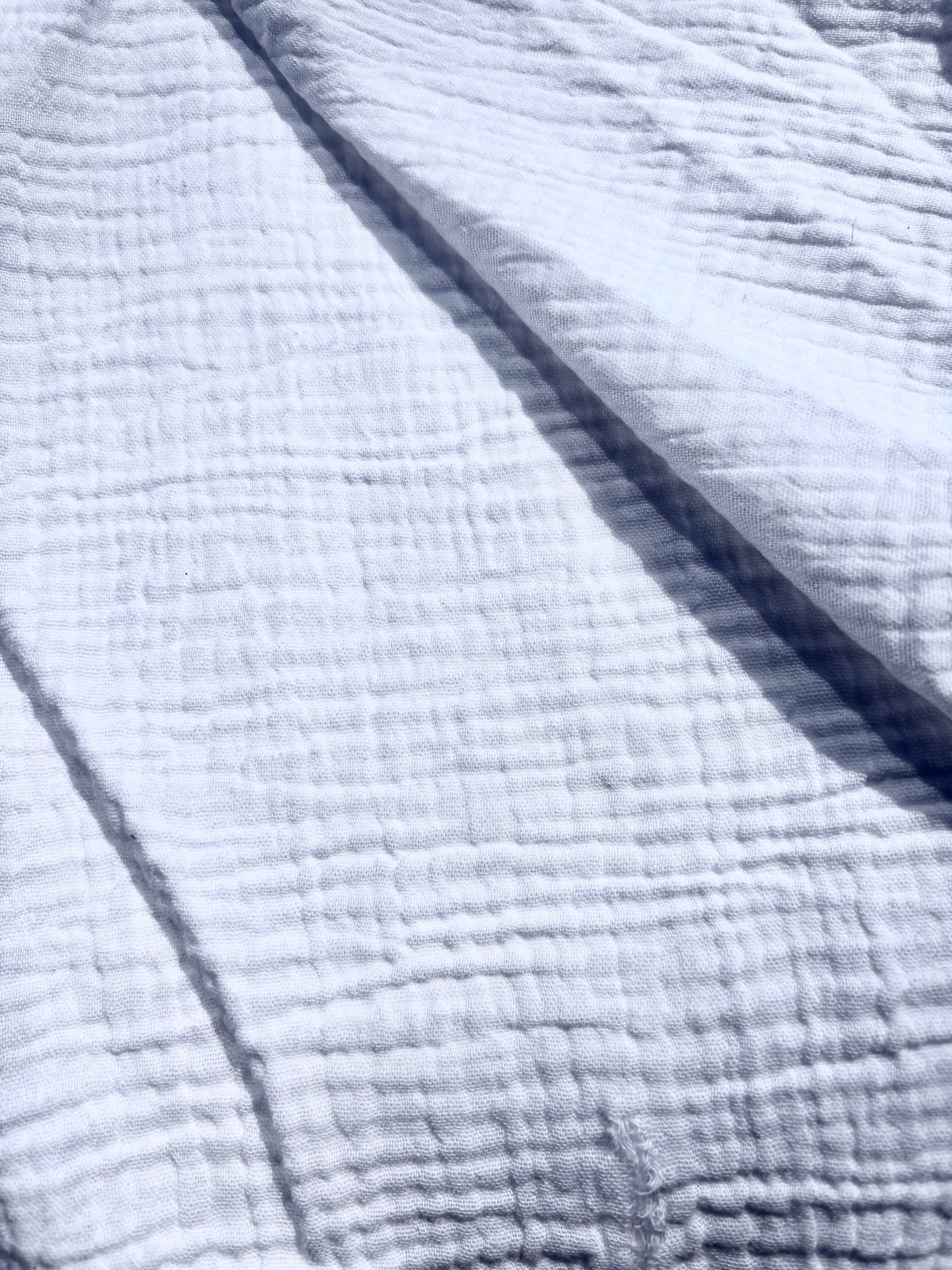 Close-up of textured double-gauze cotton in white. 