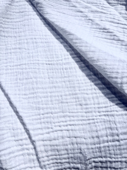 Close-up of textured double-gauze cotton in white. 