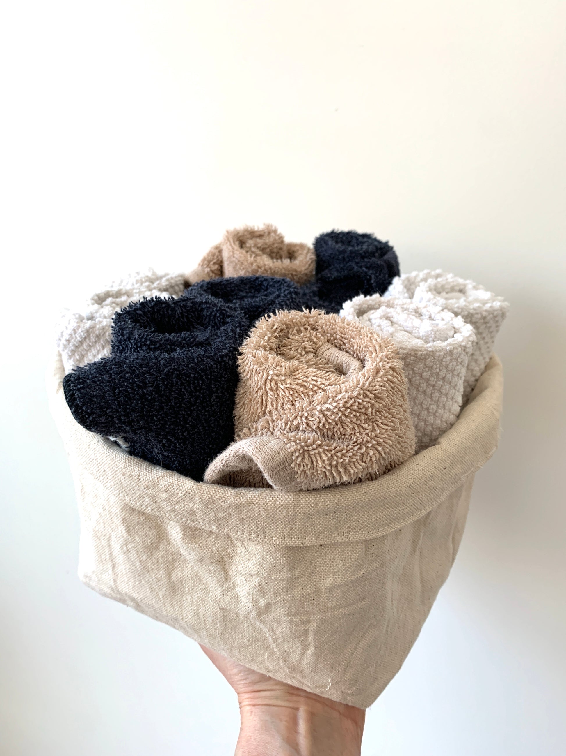 The large bucket filled with rolled facecloths