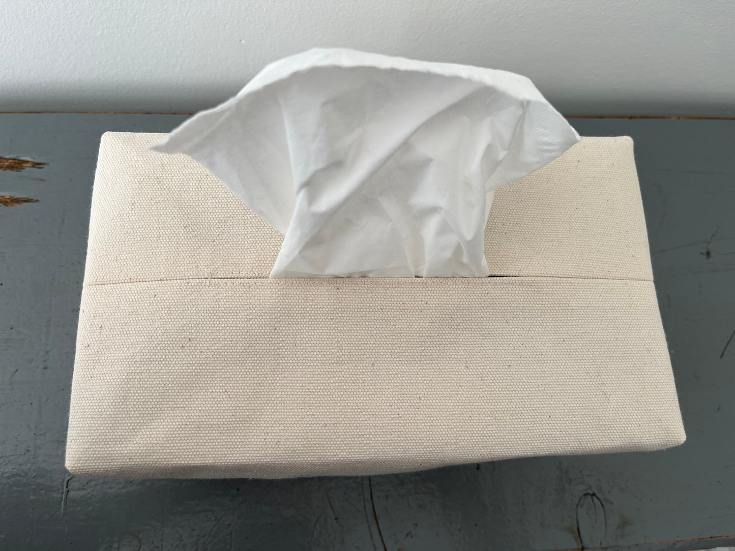An upclose image of the opening for the tissue topstitched for durability
