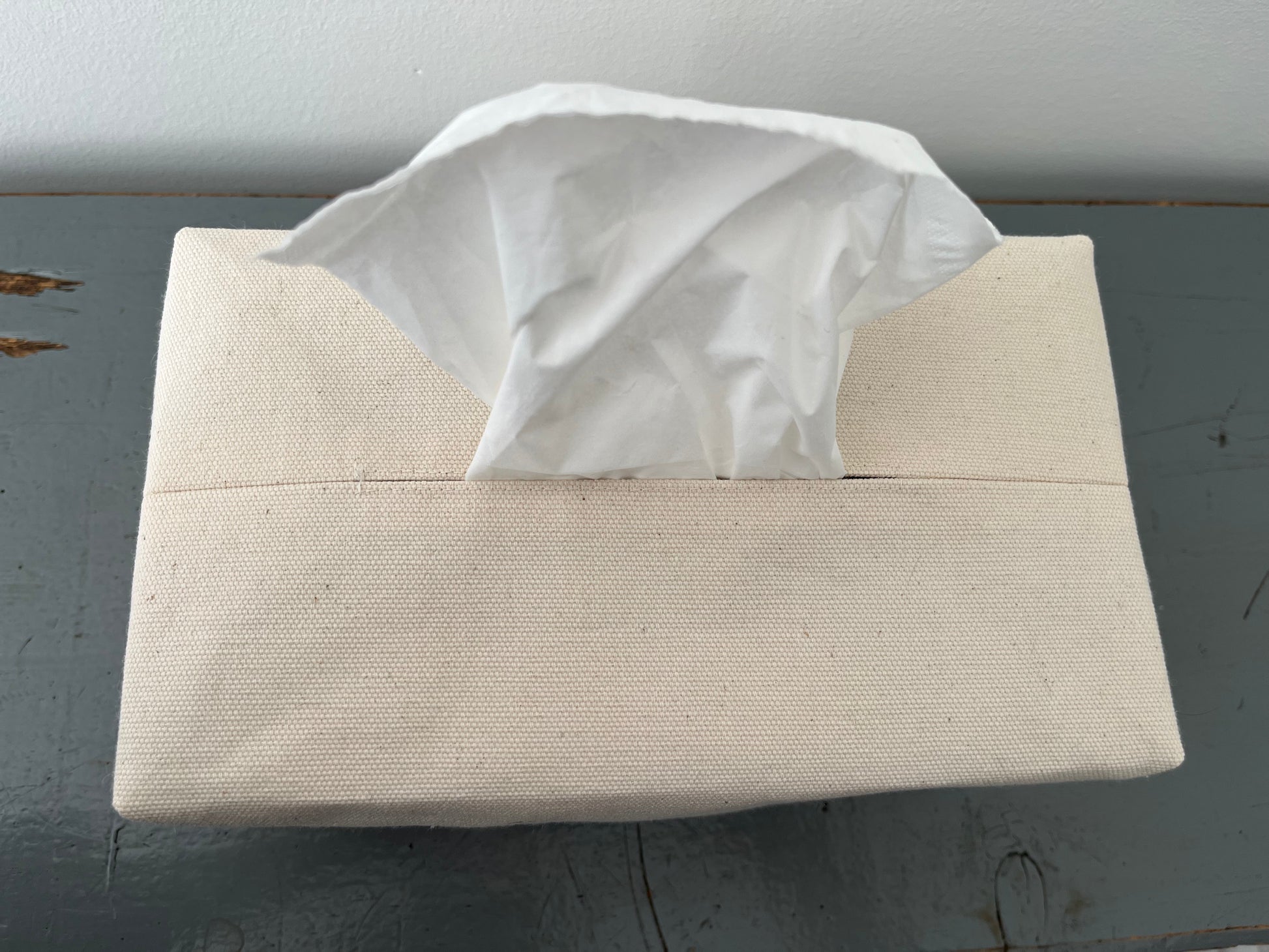 An upclose image of the opening for the tissue topstitched for durability