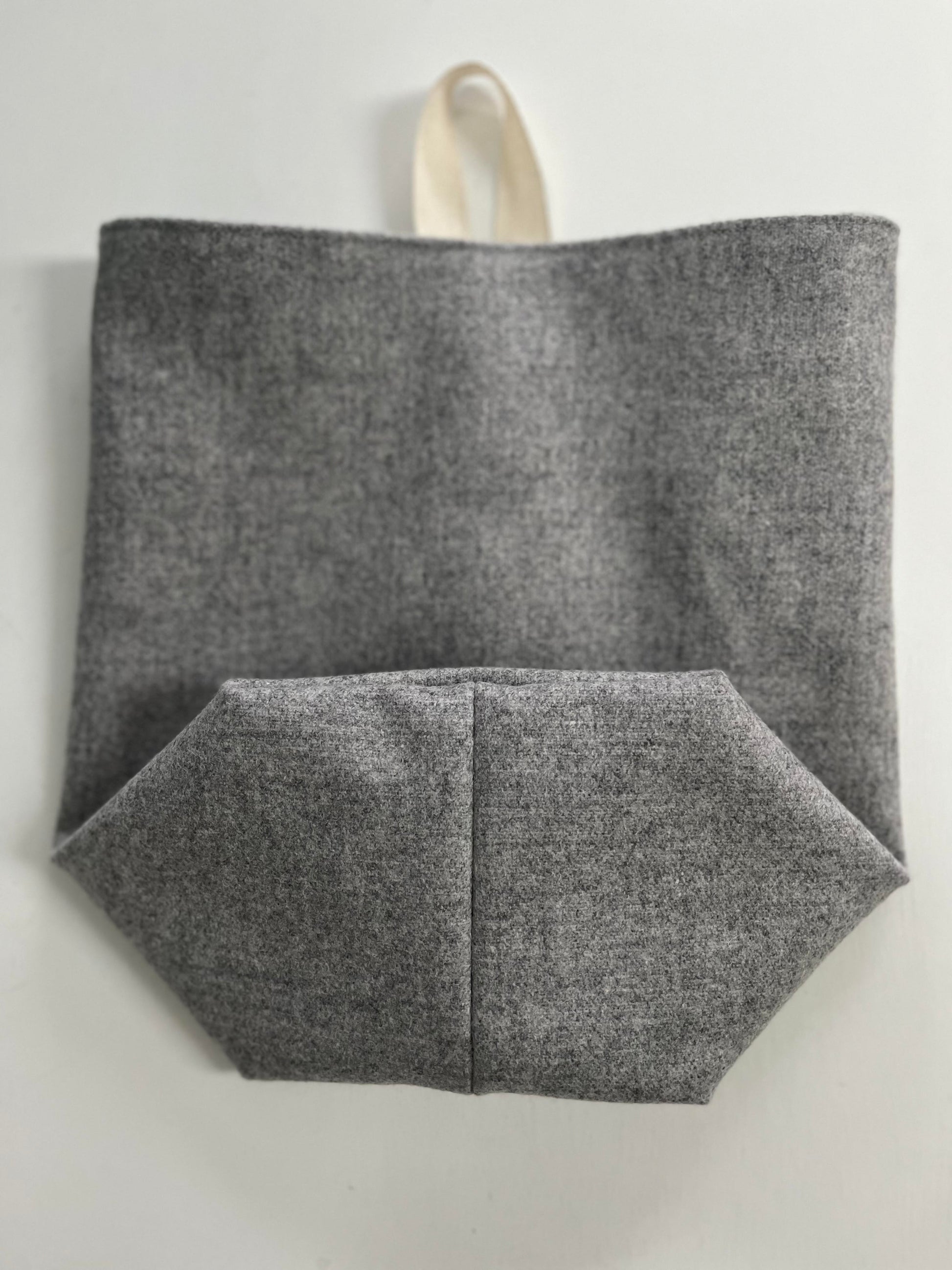 The all purpose sack folded, showcasing the boxed bottom and the natural cotton ribbon for hanging.