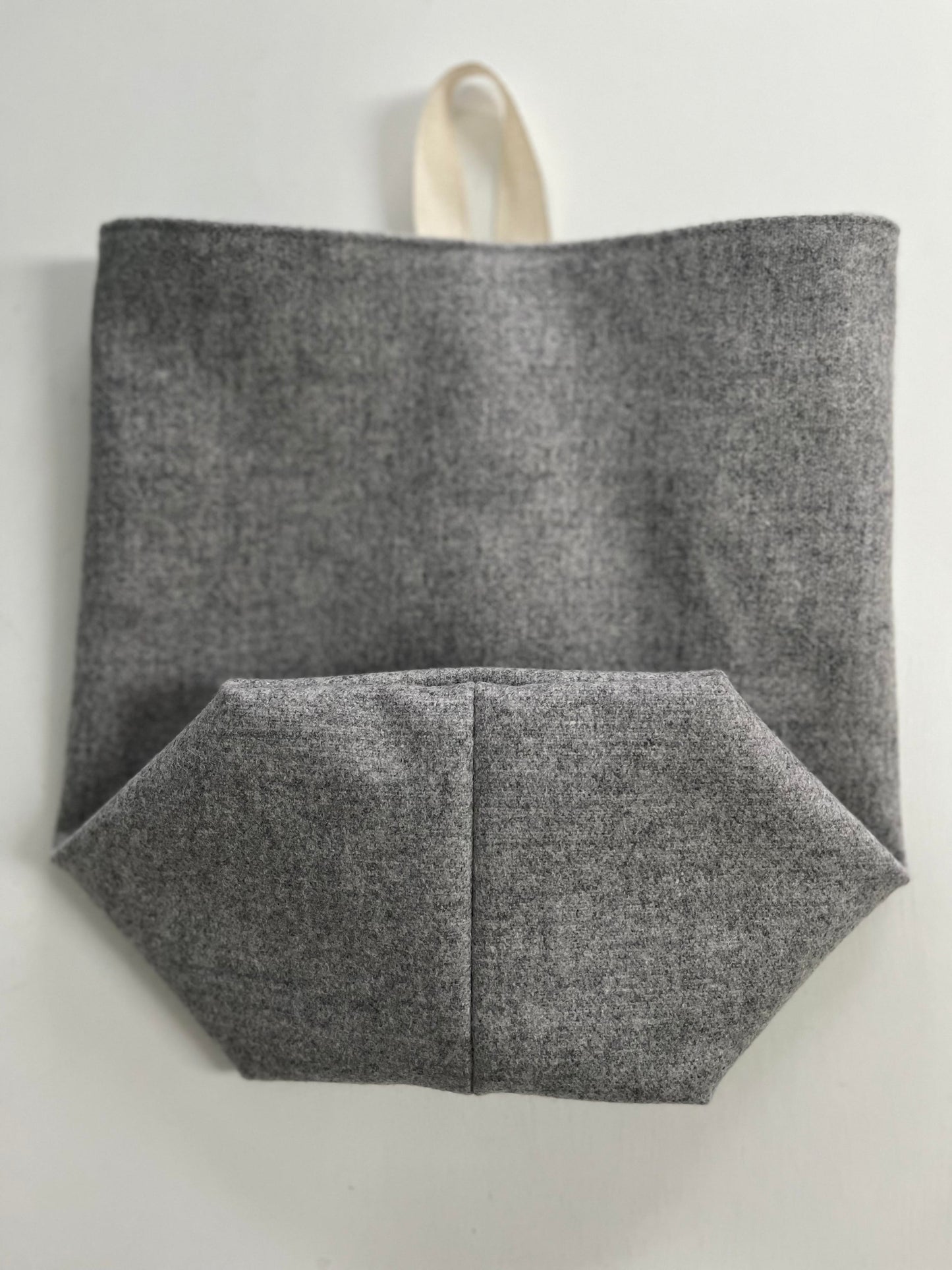 The all purpose sack folded, showcasing the boxed bottom and the natural cotton ribbon for hanging.
