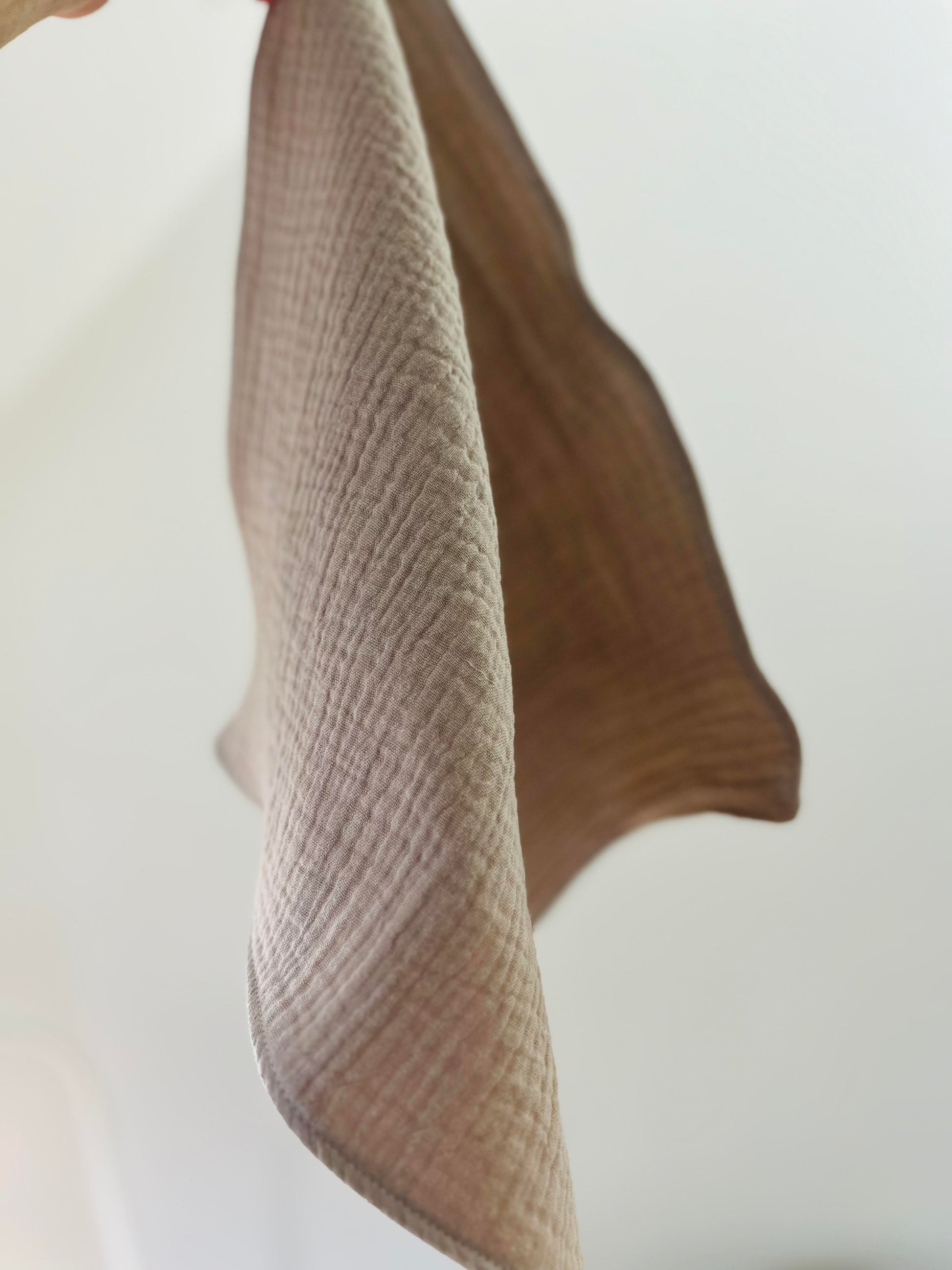 One face cloth hangs from a peg. The background is white.